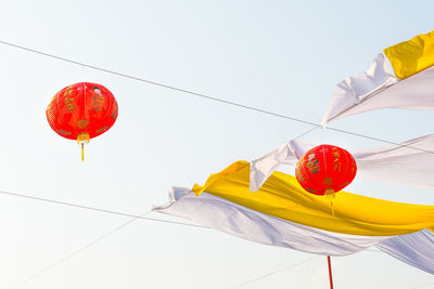 Low angle view of lanterns against clear sky