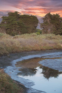 Scenic view of land against sky during sunset