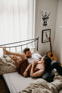 Young woman lying on bed at home