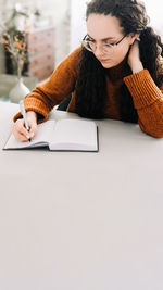 Young woman using laptop on table