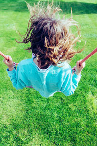 High angle view of girl playing in grass