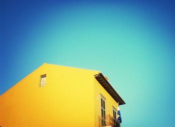 Low angle view of building against clear blue sky