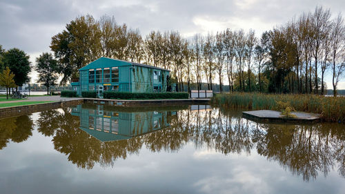 Reflection of trees in lake against sky