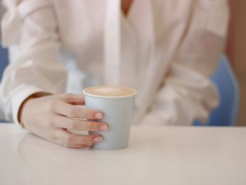 Woman holding coffee cup