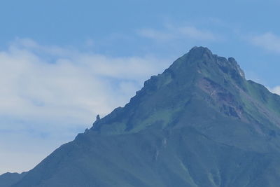 Low angle view of snowcapped mountains against sky