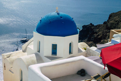 Panoramic view of sea and buildings against blue sky