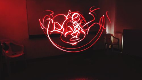 Illuminated light painting on wall at night