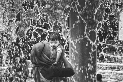 Full length of boy standing in water