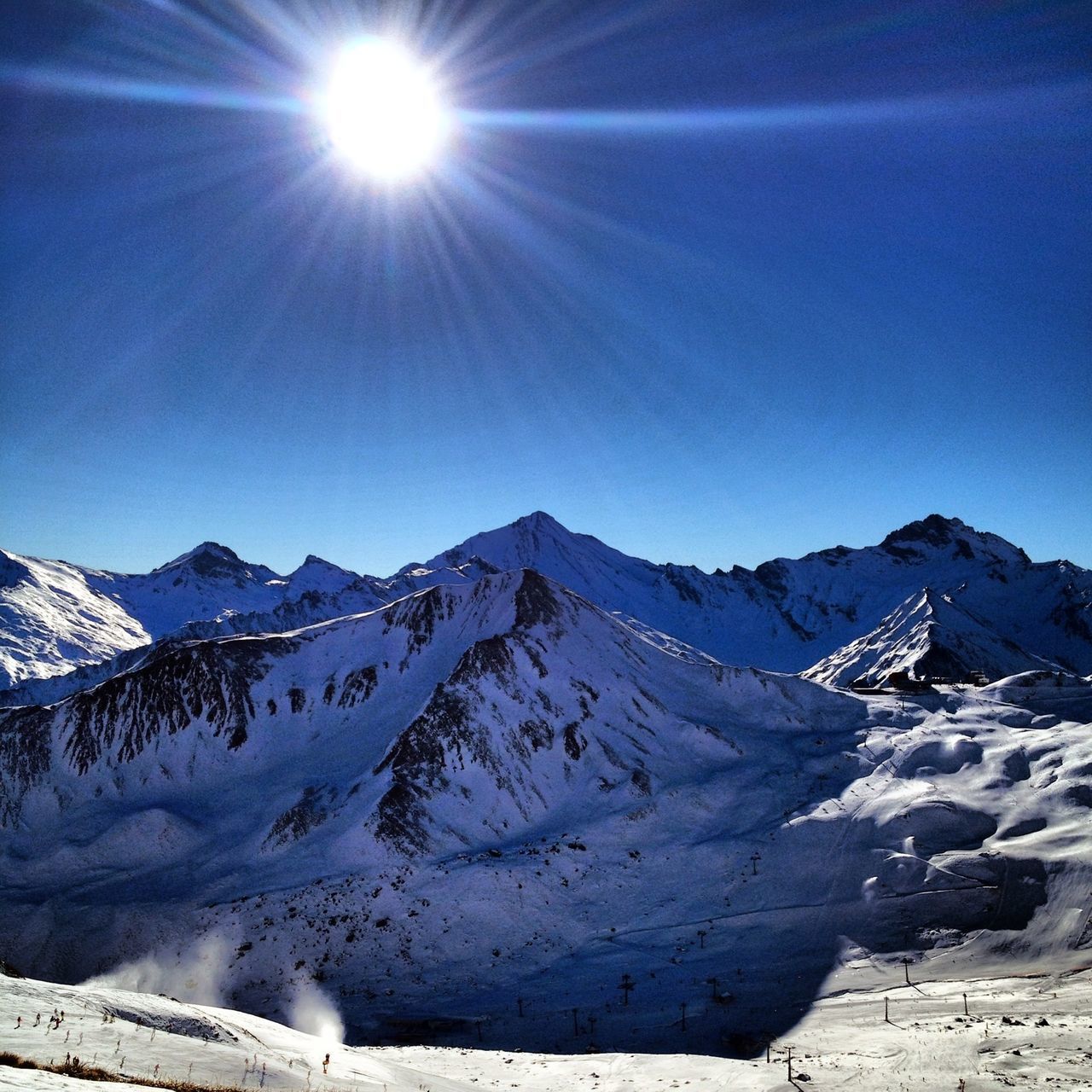 snow, mountain, winter, cold temperature, mountain range, tranquil scene, snowcapped mountain, tranquility, scenics, season, beauty in nature, landscape, sunlight, nature, blue, sun, clear sky, weather, non-urban scene, sunbeam