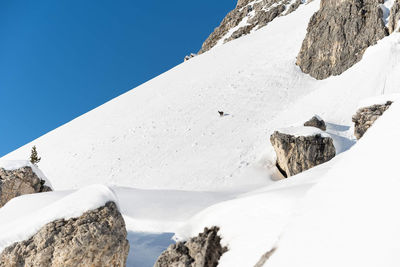 Scenic view of snowcapped mountains against clear sky