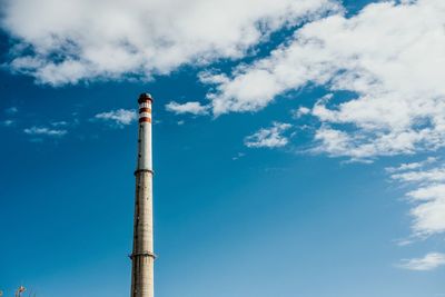 Low angle view of factory against blue sky