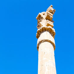 Low angle view of monument against blue sky