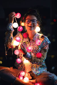 Portrait of smiling woman with christmas tree