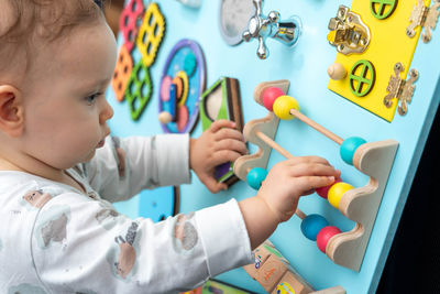 Close-up of boy playing with toy