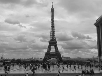 Eiffel tower against cloudy sky