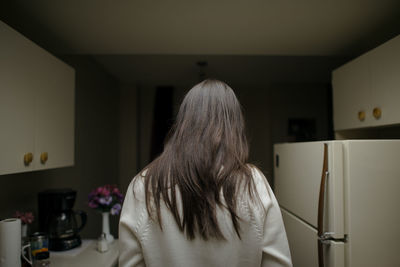 Rear view of woman at home