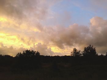 Silhouette of landscape against cloudy sky