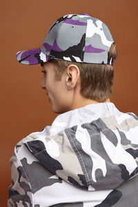 Portrait of boy wearing hat against wall