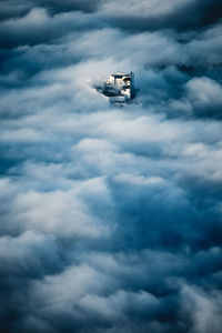 Fortress hohensalzburg rising above a sea of clouds, salzburg, austria