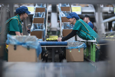 Two women working in apple factory