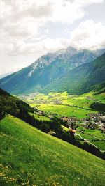 Scenic view of mountains against cloudy sky