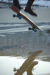 Low section of man skateboarding