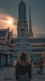 Rear view of woman walking in temple