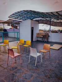 Empty chairs and tables in restaurant