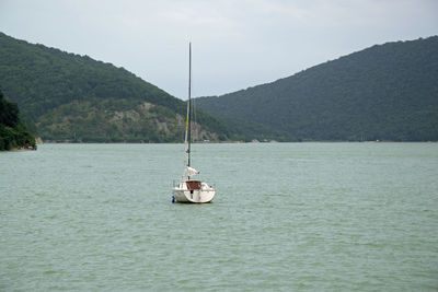 Sailboat sailing on sea against sky