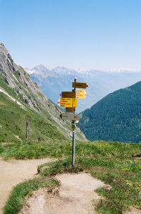 Information signs on land against mountain