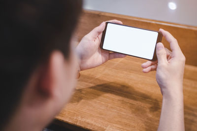 Midsection of man using mobile phone