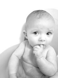 Portrait of cute baby girl in bathtub at home