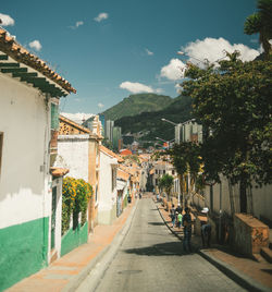 Street amidst buildings in city against sky