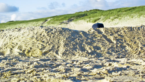 Close-up of sand at beach against sky