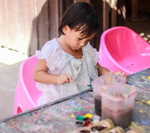 Cute girl painting on table