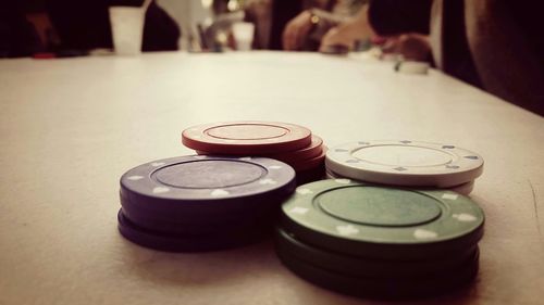 Close-up of gambling chips on table