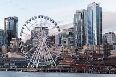 Ferris wheel in city against sky