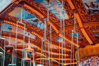 Low angle view of illuminated ferris wheel at night