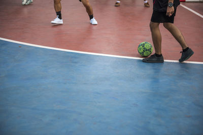 Football futsal ball and man team. indoor soccer sports hall