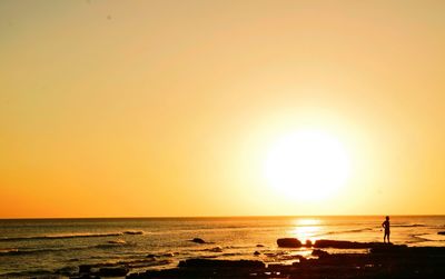 Scenic view of sea against clear sky during sunset