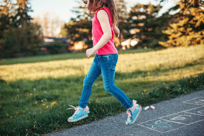 Full length of girl standing on grass