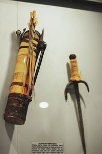 Close-up of electric lamp hanging against wall at home