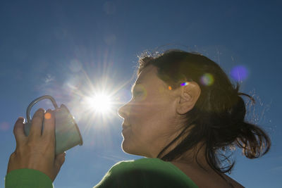 Low angle view of woman against clear sky