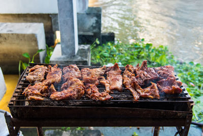 Meat on barbecue grill in yard