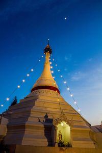 Low angle view of pagoda against blue sky