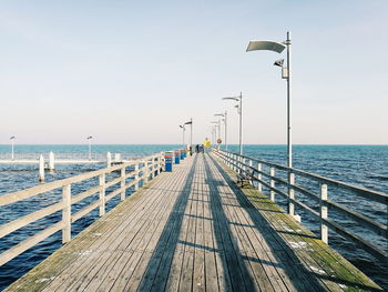 Pier over sea against clear sky