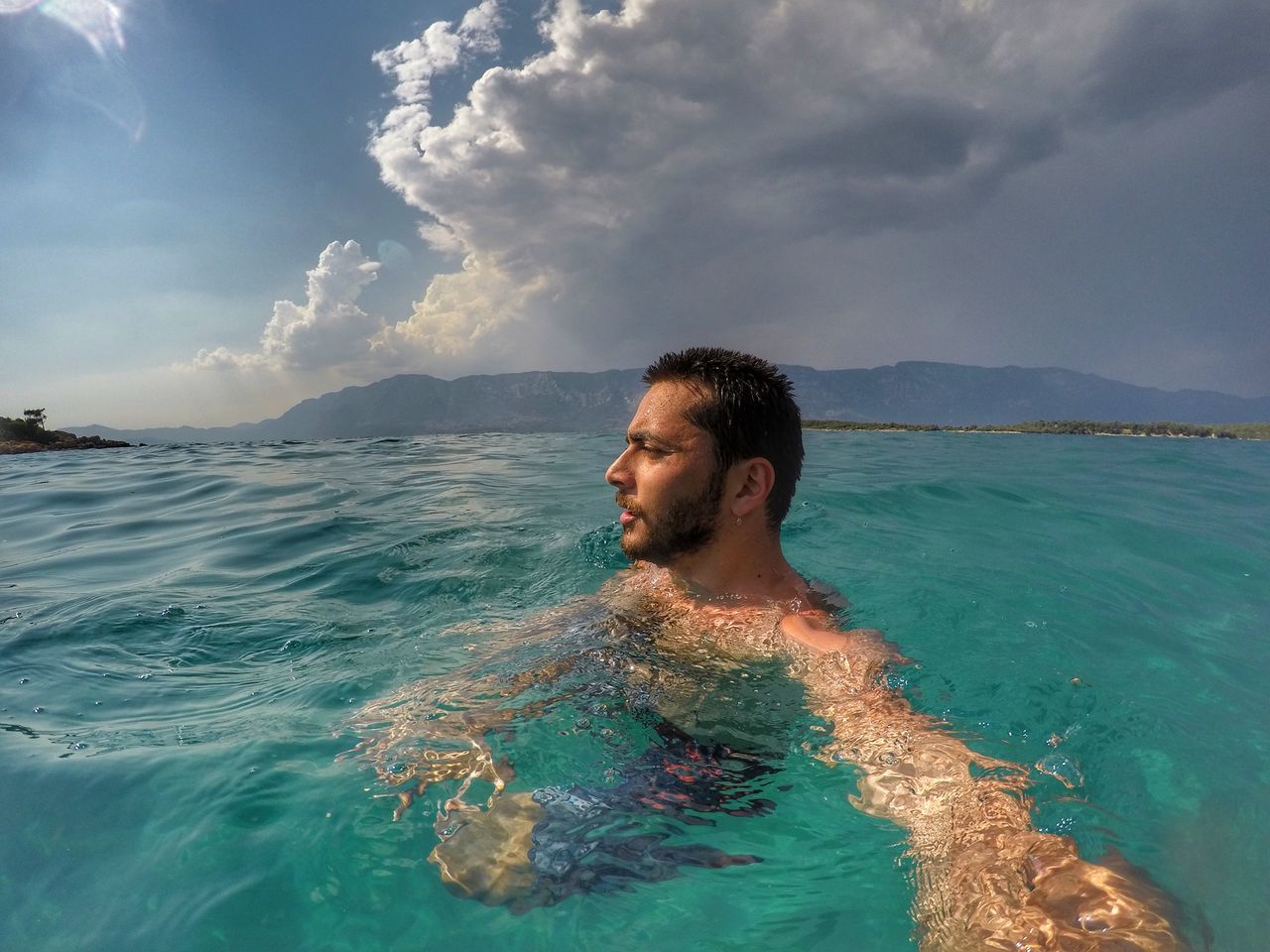 water, sky, sea, cloud - sky, one person, real people, outdoors, waterfront, nature, leisure activity, beauty in nature, day, scenics, lifestyles, vacations, young adult, people