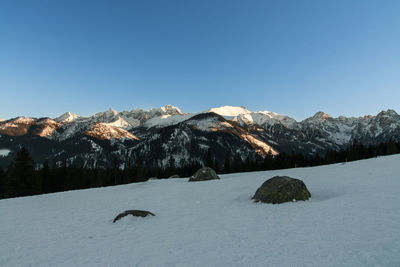 Scenic view of mountains against clear blue sky