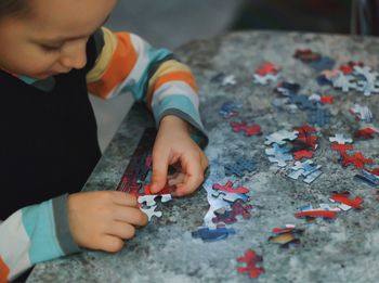 Close-up of boy playing with tattoo