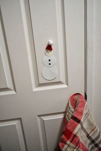 Close-up of hat on door at home